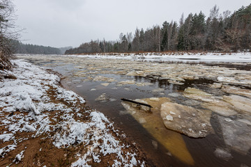 frozen river in winter countryside