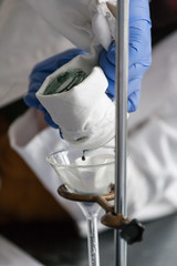 scientist working in laboratory heating chemicals making bioplastic plastics experiment