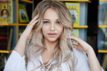 Fototapeta premium Beauty smiling happy model with natural make up and long eyelashes smiles in cafe.