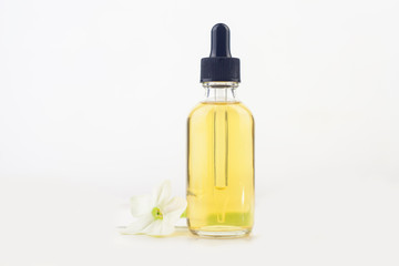 winged tobacco essential oil in  beautiful bottle on White background