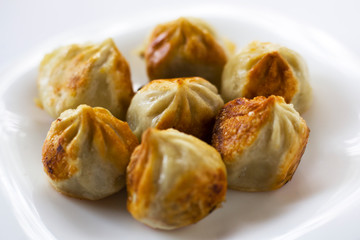 fried khinkali with a crust on a plate