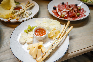 buffet table salmon toast cheese meat fruit honey on the table