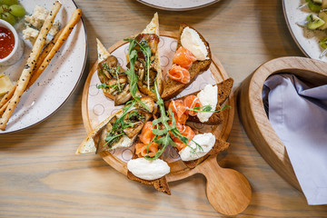 buffet table salmon toast cheese meat fruit honey on the table
