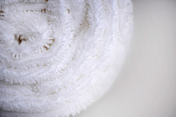 White delicate soft background of clean white close up towel rolled blanket textile texture