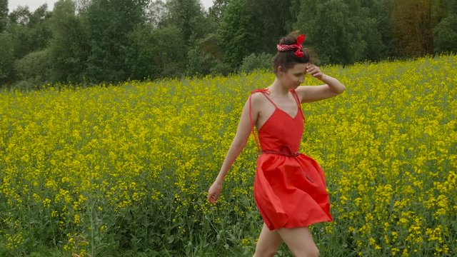 young sexy woman in red dress dancing
