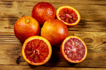 Red blood oranges on wooden table