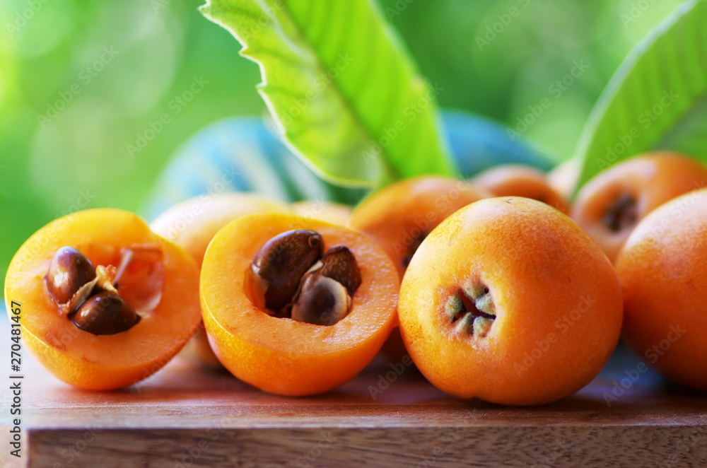 Wall mural loquat medlar fruit isolated on a green background