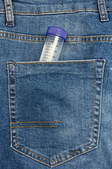 Close Up View to Test Tube Sticking Out From a Blue Jeans Pocket