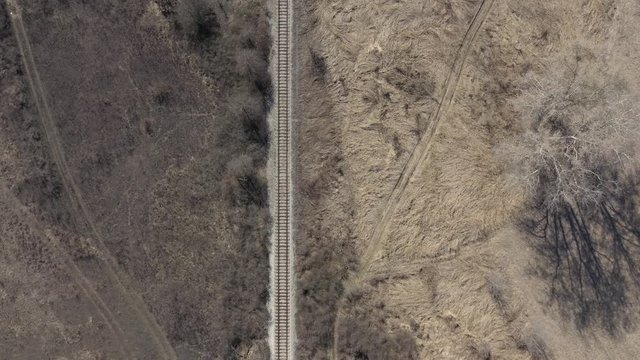 Descending on railroad in the wild nature 4K drone video