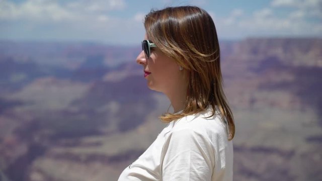 Woman walking in Grand Canyon near cliff