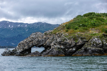 Natural stone arch in sea near Homer, Alaska