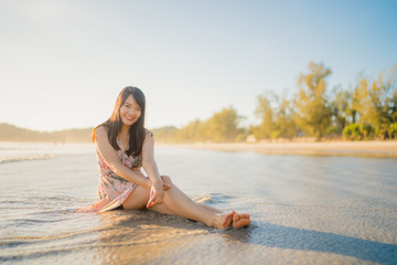Fototapeta na wymiar Young Asian woman walking on beach. Beautiful female happy relax walking on beach near sea when sunset in evening. Lifestyle women travel on beach concept.