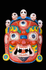 Old mask of the Bhairab god of the Hindu and Buddhist mythology, isolated on black background