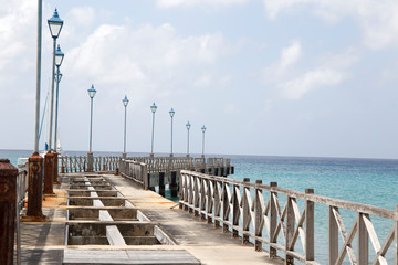 Ruined wooden pier in Barbados Caribbean sea