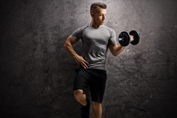 Guy exercising with a dumbbell