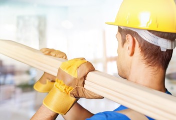 Worker on building contractor background.