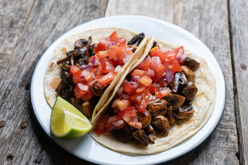 Vegan and vegetarian mexican mushrooms tacos with sauce and lime
