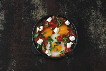 Shakshuka in a cast iron skillet. Flat Lay.