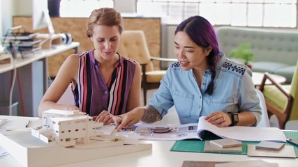 Happy coworkers working together in architectural firm