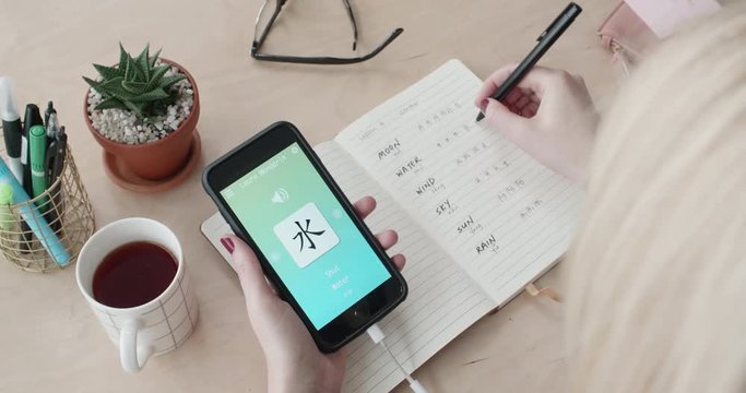 woman using foreign language learn chinese mobile phone app
