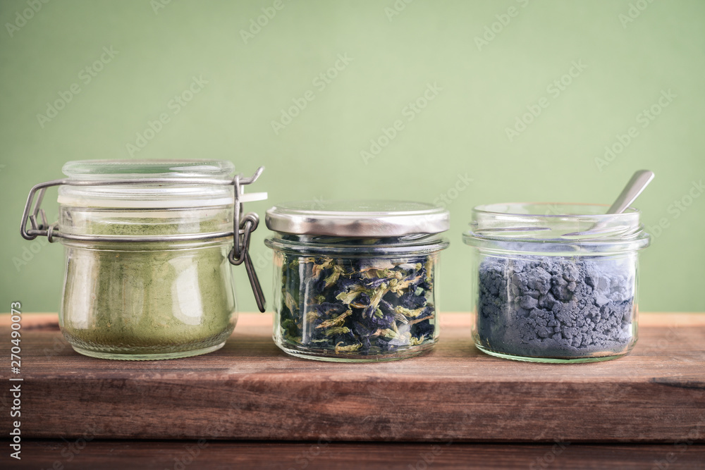 Wall mural matcha tea powder, blue matcha powder and organic dried pea flowers