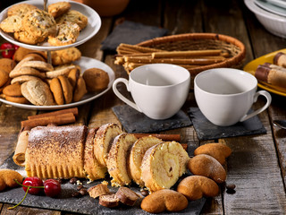 Cookies heart shape, sand rolled biscuit and cinnamon stick on wood table served dessert spoon at kitchen in rustic style. Easily digestible and quickly digestible substances.