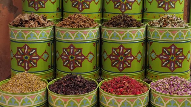 Selection of different arabian spices cosmetics on a traditional Moroccan market souk in Marrakech, Morocco. A lot of pepper, cardamon, cumin, curry