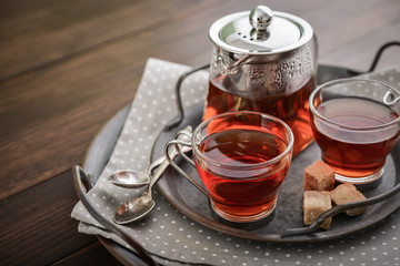 Two glass cup of tea with teapot