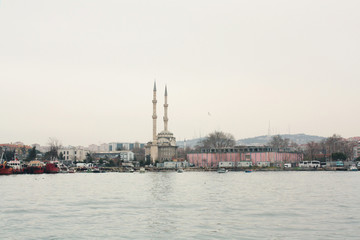 Fototapeta na wymiar Mosque and port constructions in Kadıköy shore, Istanbul, Turkey. 