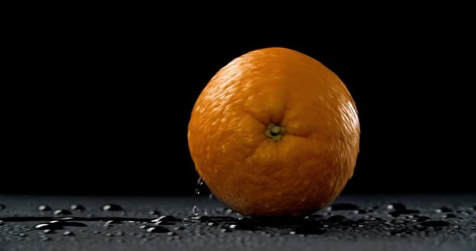 Rolling orange on dark background