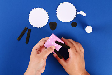 Diy Eid al adha lamb sheep sweet candy paper, wooden sticks for ice cream on blue background