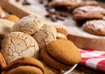 Oatmeal cookies on red kitchen gingham checkered cotton fabric on table in farm-style. Macaron close up. Checkered tablecloth. High content of nutrients.