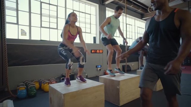 Dedicated people doing box jumps