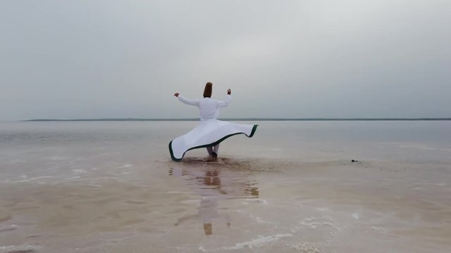 sunset and whirling at the sea, sufi. sufi whirling (Turkish: Semazen) is a form of Sama or physically active meditation which originated among Sufis. 4k