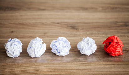 Creative idea concept. Crumpled paper balls on wood background