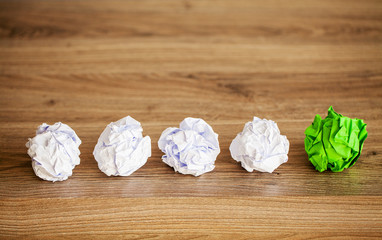 Creative idea concept.Inspiration, New idea and Innovation concept with Crumpled Paper on wood...