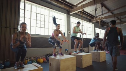 Group of people in crossfit class in gym