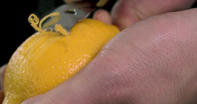 Using citrus zester on a lemon