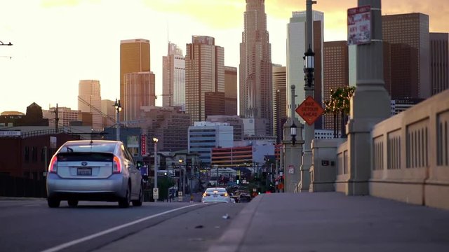 Slow motion of electric car driving to downtown cityscape Los Angeles, California. Concept of city life, financial downtown, modern urban lifestyle.