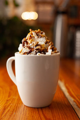 Spicy cocoa with whipped cream and caramel topping for winter evenings