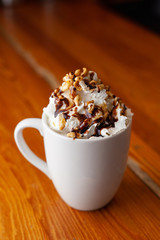 Spicy cocoa with whipped cream and caramel topping for winter evenings