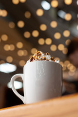 X-mas hot beverage on bokeh-style background with blurred lights