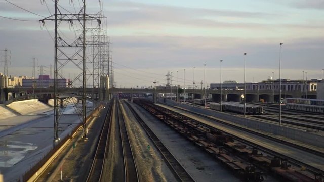 Dolly gliding view of Los Angeles train depot. Freight trains containers in industrial zone. Concept of urban shipping, fossil energy, freight industry in America.