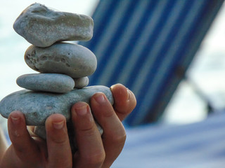 Kid Playing with balancing stones.