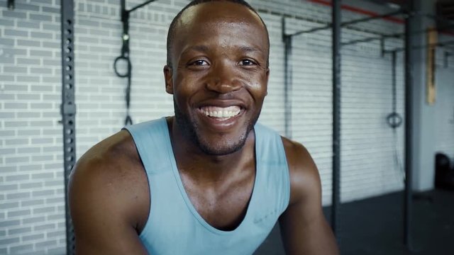 Confident muscular black man smiling in a gym