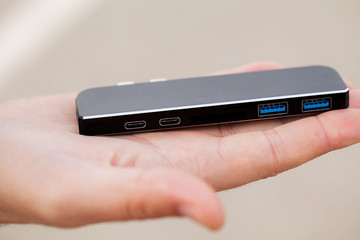 Man holding mini adapter for laptops and flash memory