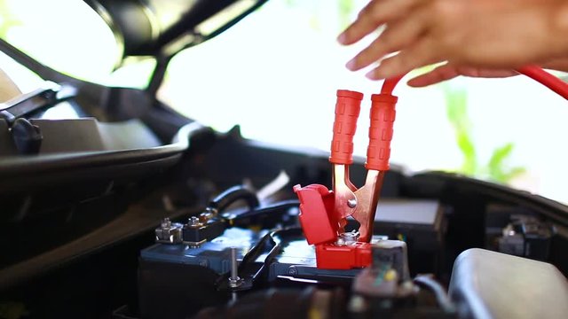 cable connection procedure car battery. step of charging car with electricity trough cables. first connect anode then follow connect negative connector battery. 