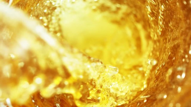 Super slow motion of pouring beer or spirit drink in twister shape. Filmed on high speed cinema camera, 1000 fps.