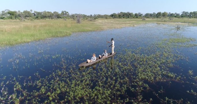 Aerial view of tourists enjoying a ride on a Mokoro - traditional canoe in the Okavango Delta