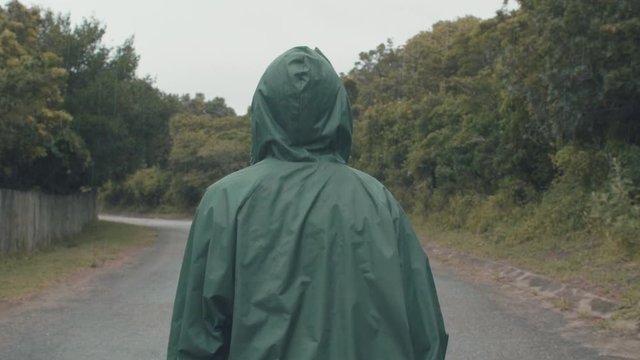 Lonely person walking in the rain alone